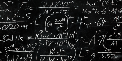 A black chalkboard filled with complex mathematical equations and formulas written in white chalk.